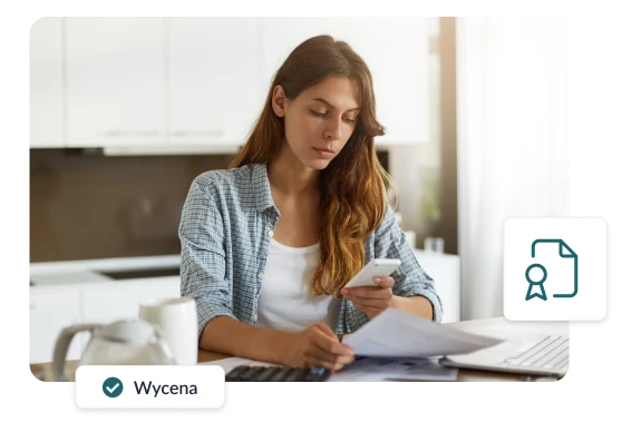Kobieta przeglądająca dokumenty przy komputerze, dokonująca wyceny majątku, trzymająca w ręku telefon.